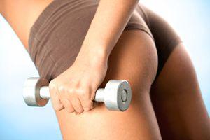 Female elastic butt and dumbbell in hands