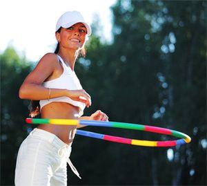 Girl twists a hoop for weight loss