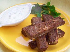 Chopsticks with garlic in the form of sticks on a yellow plate