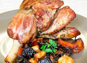 Portion of lamb with prunes and fried crust on the bone