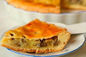 A piece of pie with mushrooms and cabbage