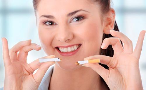 Broken cigarette in the hands of a girl