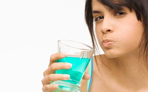 Girl rinses her mouth