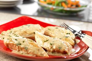 Chicken in cream sauce on a red plate