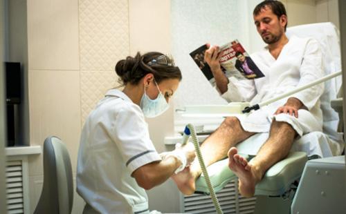 A man sits in a pedicure chair