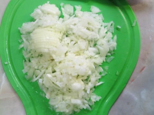 Sliced ​​onions on a green cutting board