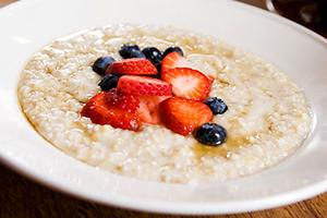 A slice of chopped strawberries crowns the porridge