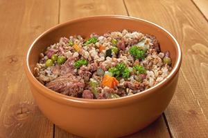Clay bowl with porridge on a wooden table
