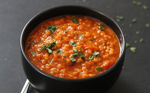 Bright lentils and sprinkled greens in a bowl