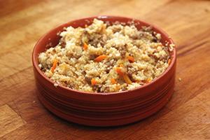 Barley porridge with meat in a wooden bowl