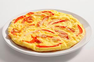 Omelet with tomatoes and cheese in a pan