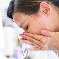 Girl washes foam with clean water