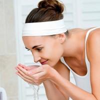 Young woman washing her hair carefully tied