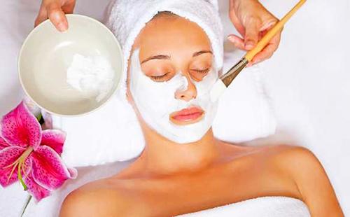 Girl in a white towel and with a pink flower
