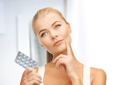 Girl holds pills in hand
