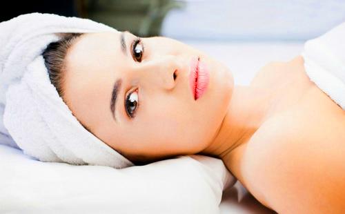 The girl on cosmetic procedures strictly looks with dark eyes.