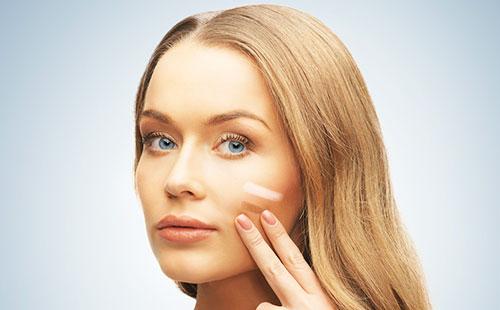 Foundation on the cheek of a girl