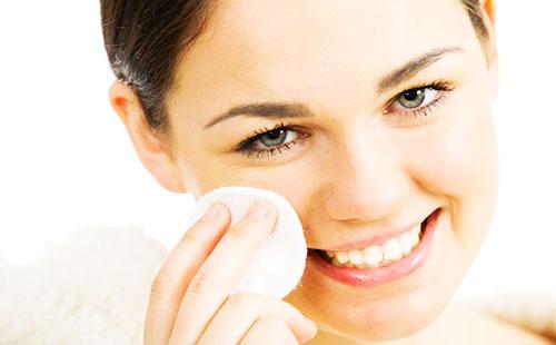 Wipes his face with a cotton pad