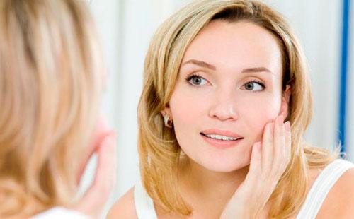 Young woman looking in the mirror