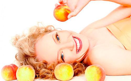 Girl holds peach in hand