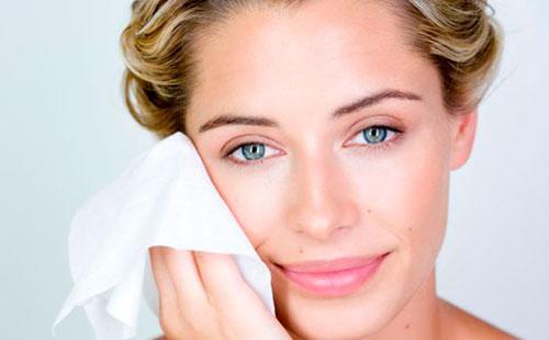 Girl wipes her face with a napkin