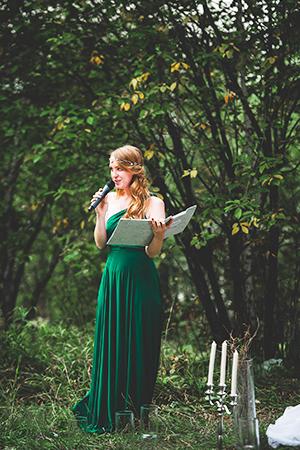 Catherine in a long green dress speaks into the microphone