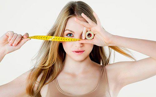 Girl holds a centimeter in her hands