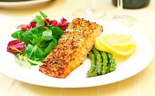 Baked fish on a plate with vegetables