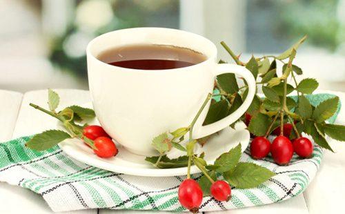 Rosehip berries broth in a white cup