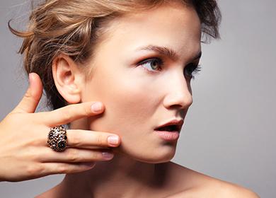 Beautiful woman touches her cheeks