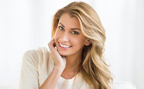 Happy woman touching face