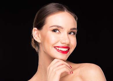 Beautiful woman flirtatiously holds her chin