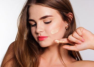 Beautiful girl with a smear of cream on her cheek