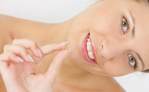 Girl holds capsule in hand