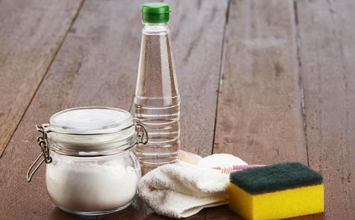 Vinegar, soda and sponge on wooden boards