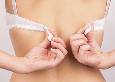 Girl messing with a white bra clasp