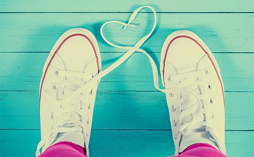 White sneakers on the green floor