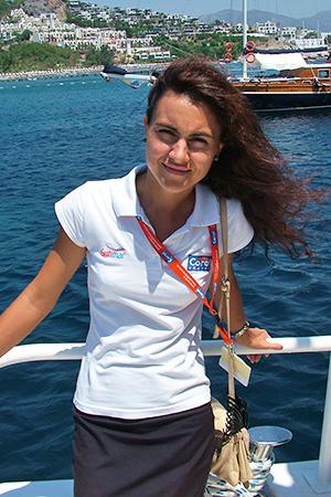 A girl in a white blouse stands at the handrail