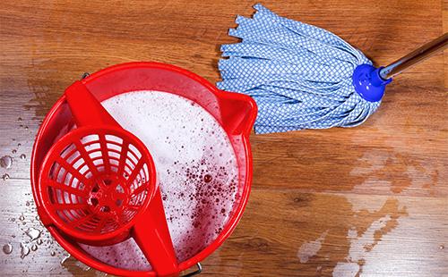 Wet floor and a mop with a bucket