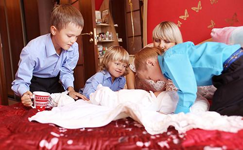 Boys bustle over little brother