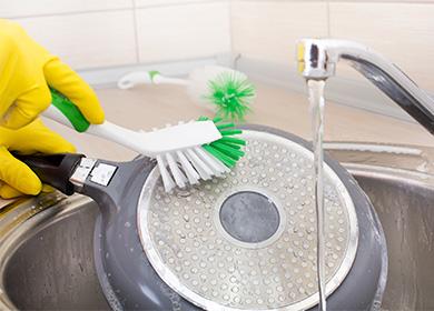 Cleaning the pan with a brush