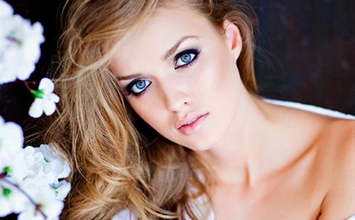 Blue-eyed blonde in a white blouse