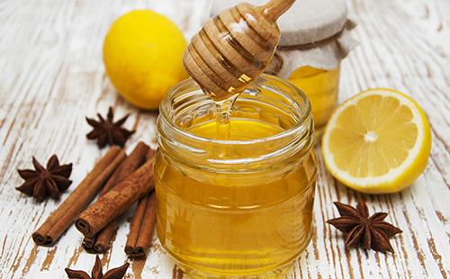 Jar of honey and cinnamon sticks
