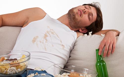 The guy fell asleep for food and dirty his shirt