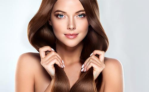 Brunette holds hair in her hands