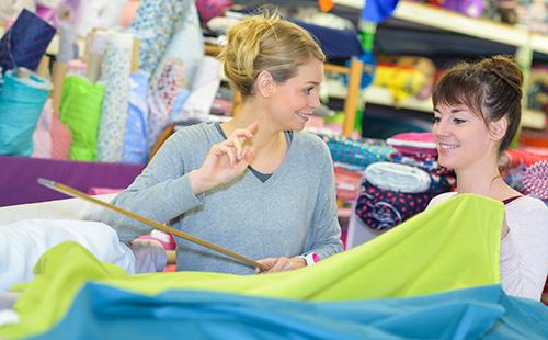 Woman at the store chooses fabric