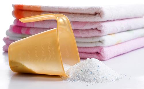 Measuring cup in front of a stack of towels