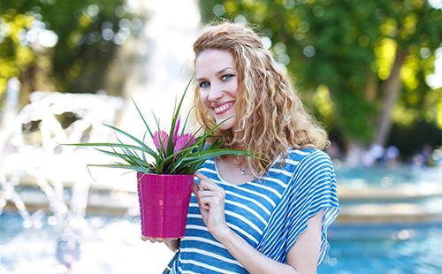 Girl with a flowerpot in hands