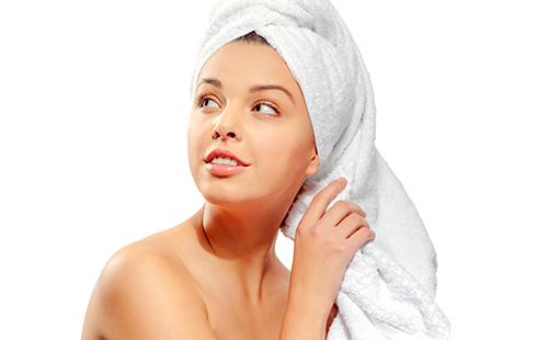 Beautiful girl with a towel on her head