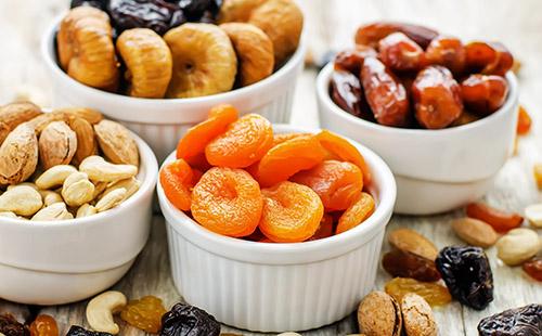Assorted dried fruits in a plastic bowl